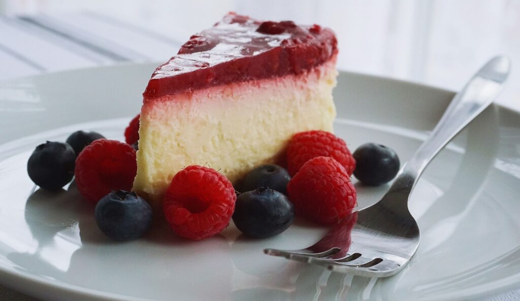 Slice of cheesecake with berries on a plate