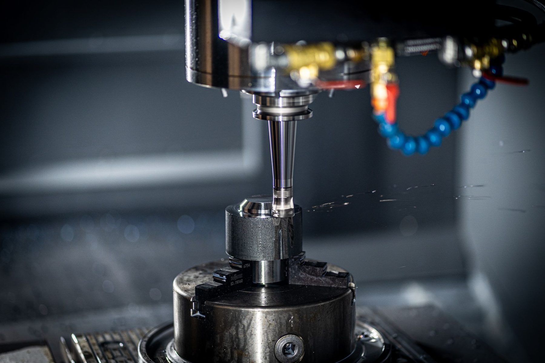Milling machine spindle cutting a metal part