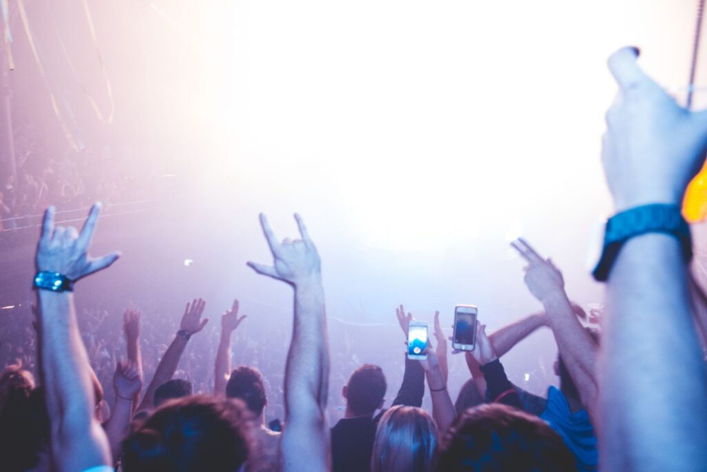 Crowd with raised hands in bright light