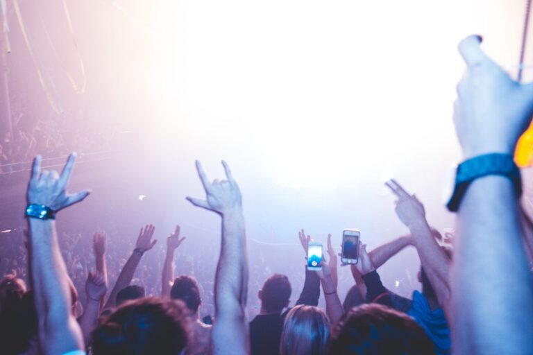 Crowd with raised hands in bright light