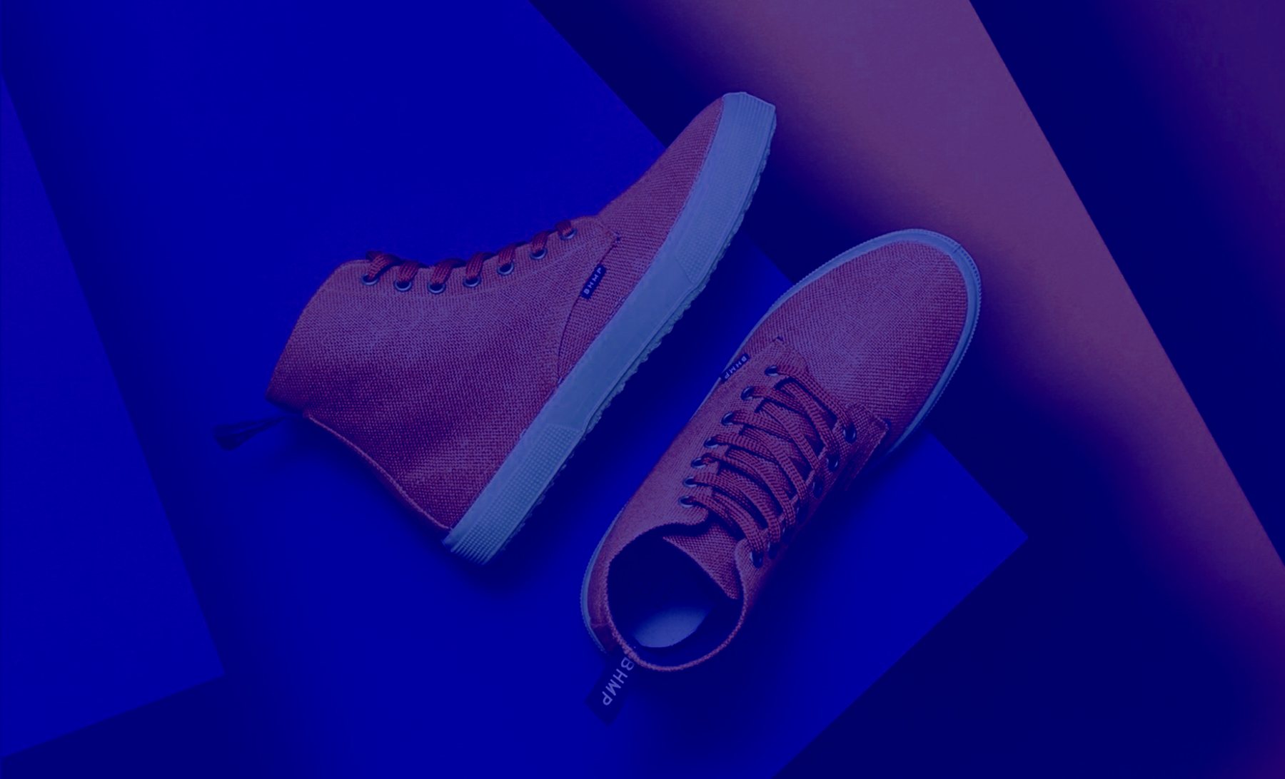 Pair of high-top sneakers lit in deep blue