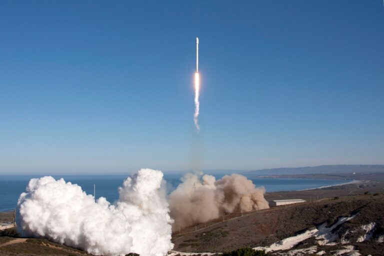 Rocket lifting off above a cloud of smoke