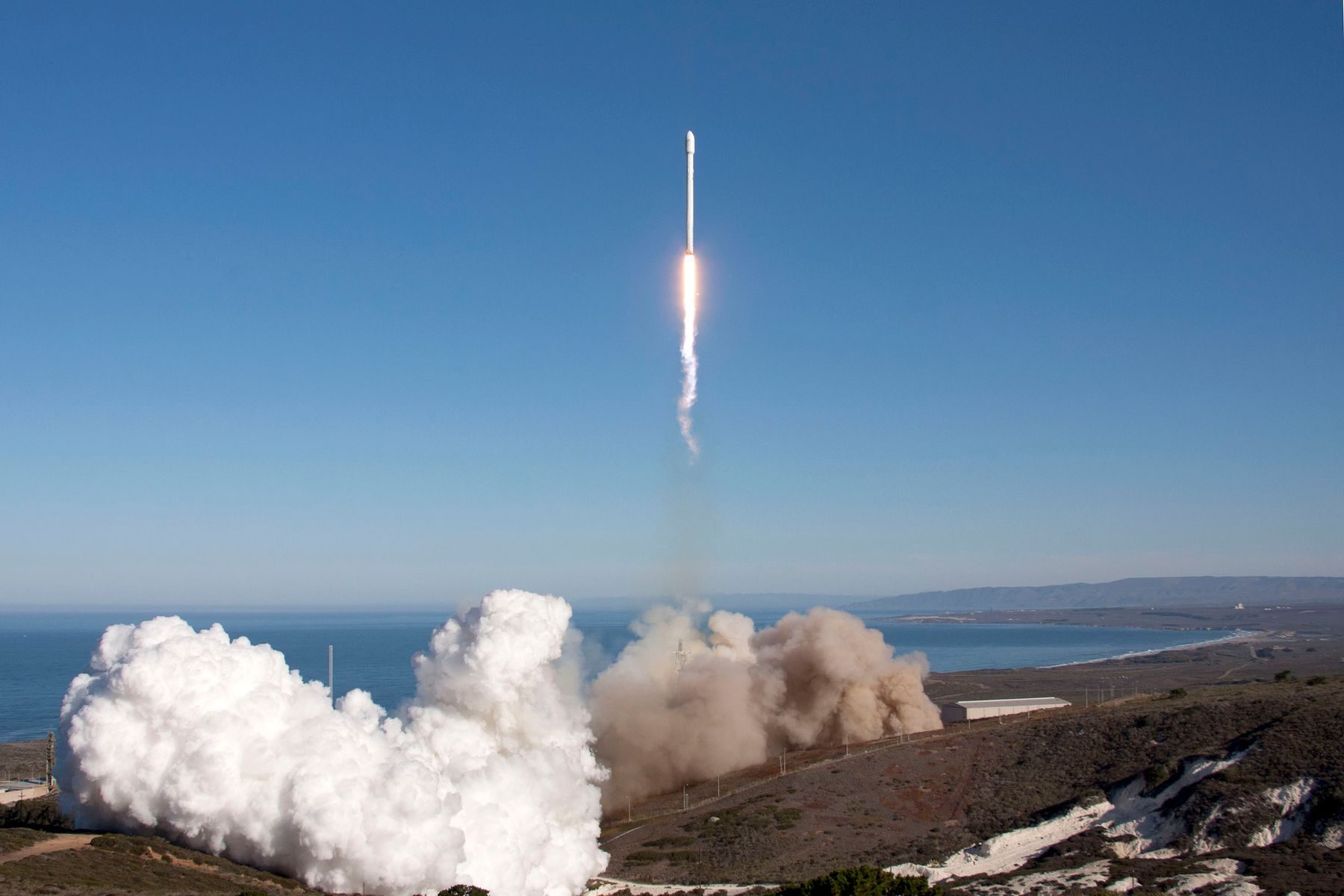 Rocket lifting off above a cloud of smoke