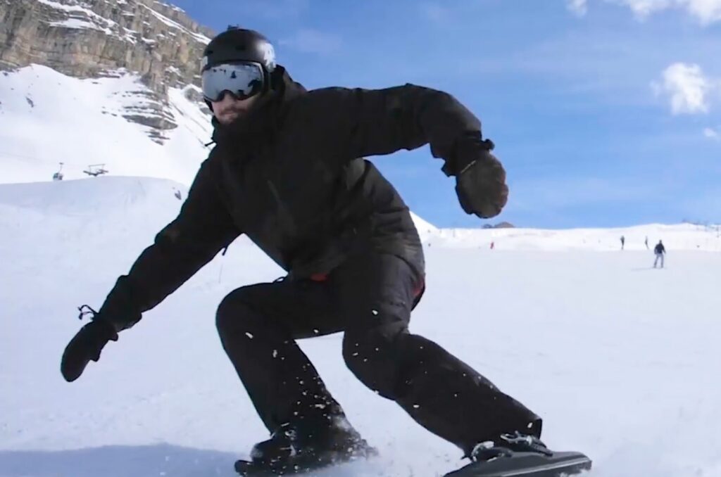 Rider sliding down a snowy slope on Snowfeet II