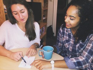 Two young entrepreneurs going over notes at a table